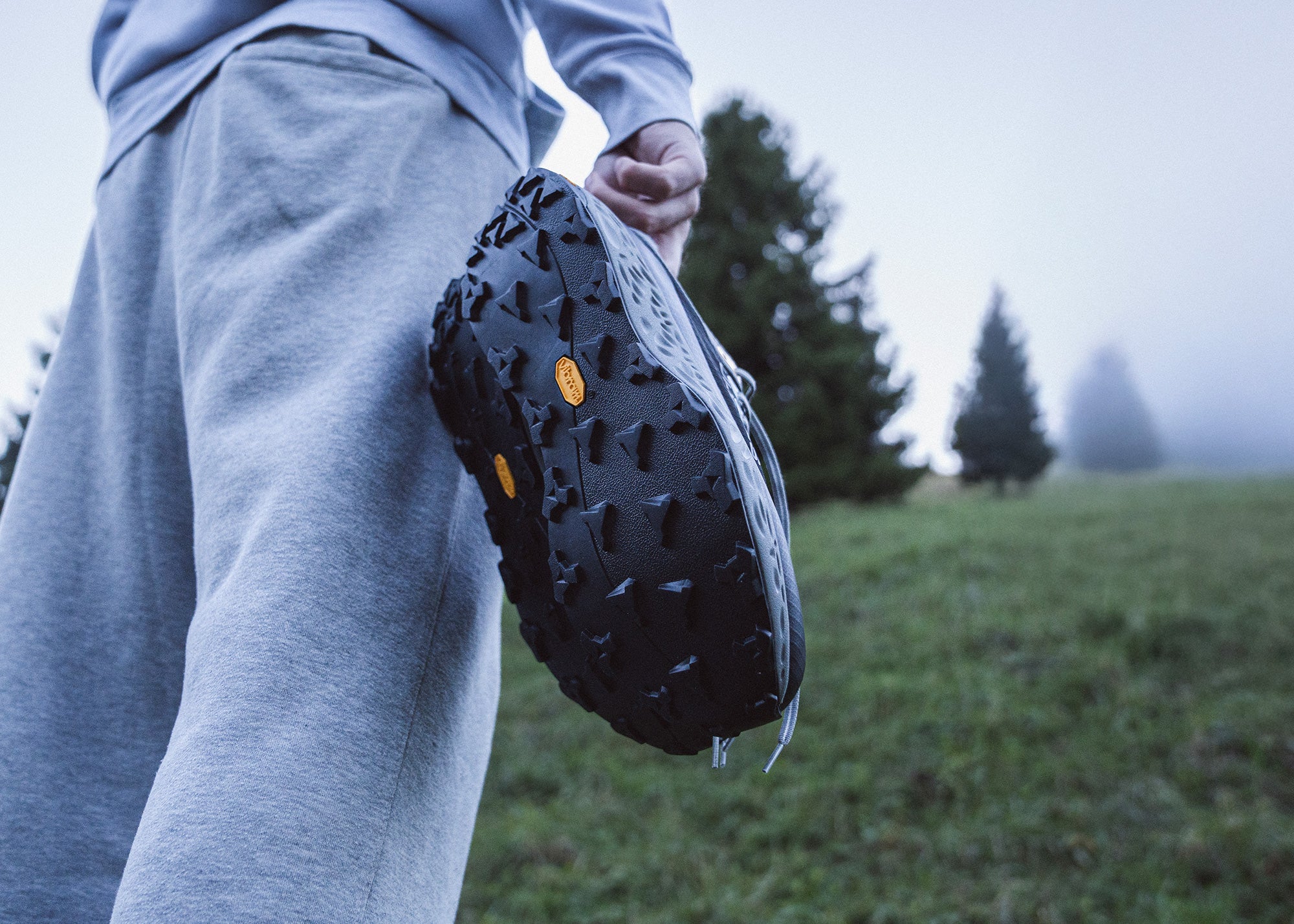 Trail running shoe sole on grassy terrain