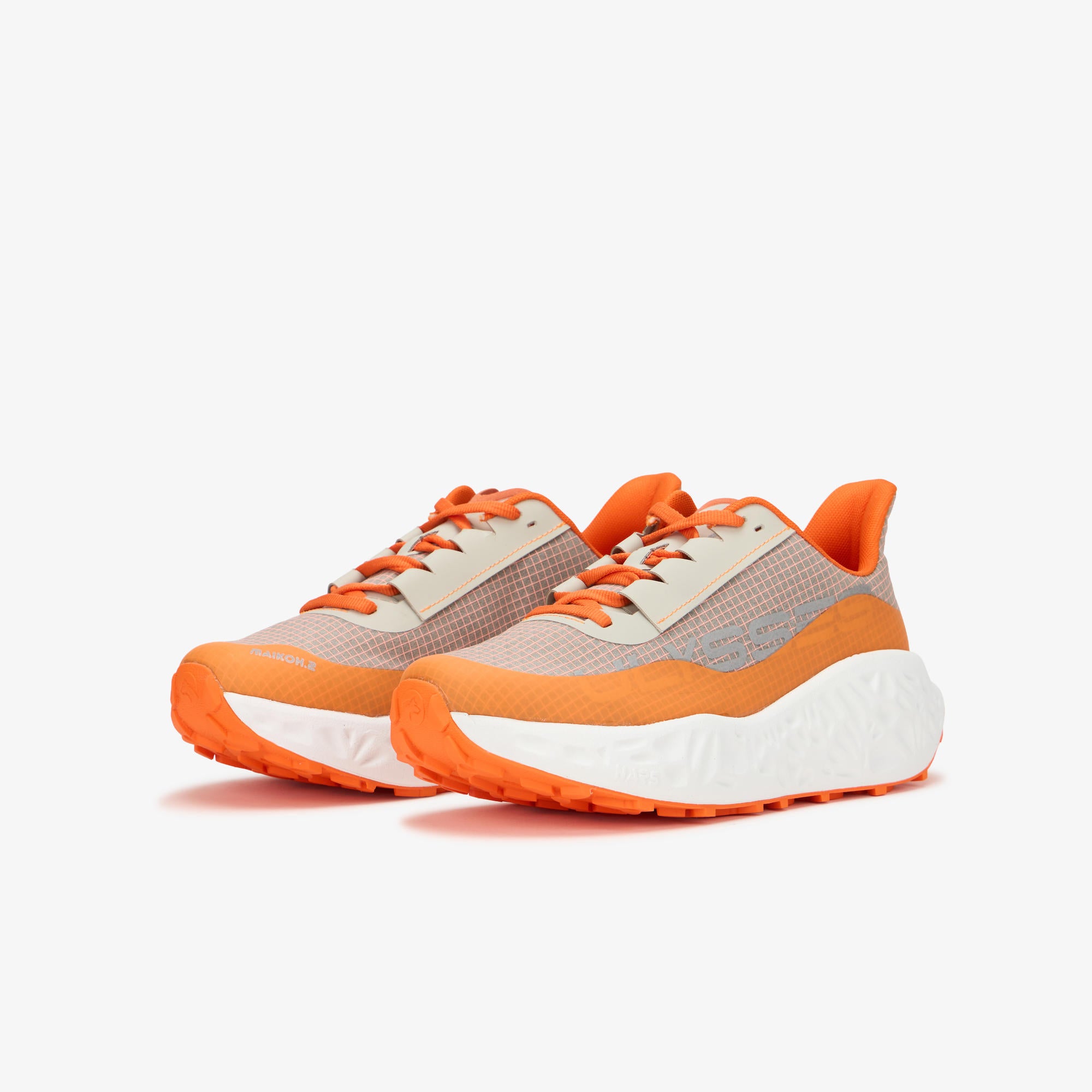 A pair of athletic sneakers with a light gray mesh upper, bright orange accents on the laces, collar, and outsole, and a chunky white midsole, shown against a plain light gray background.