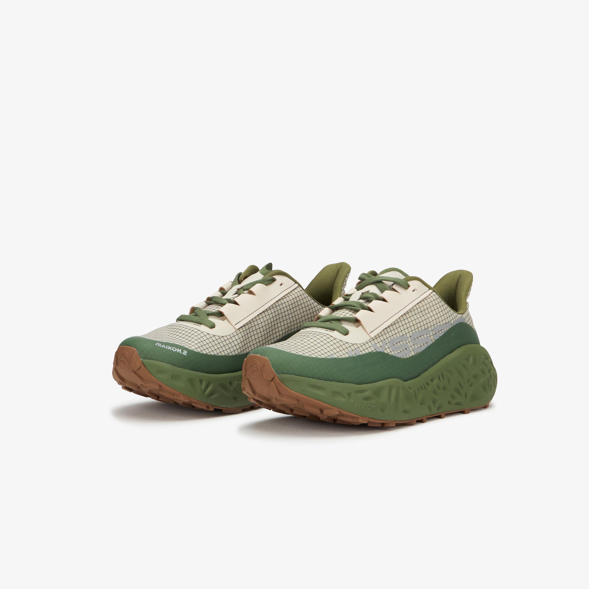 A pair of low-top sneakers in off-white mesh and olive green, featuring chunky textured green midsoles and brown rubber outsoles, shown on a light gray background.