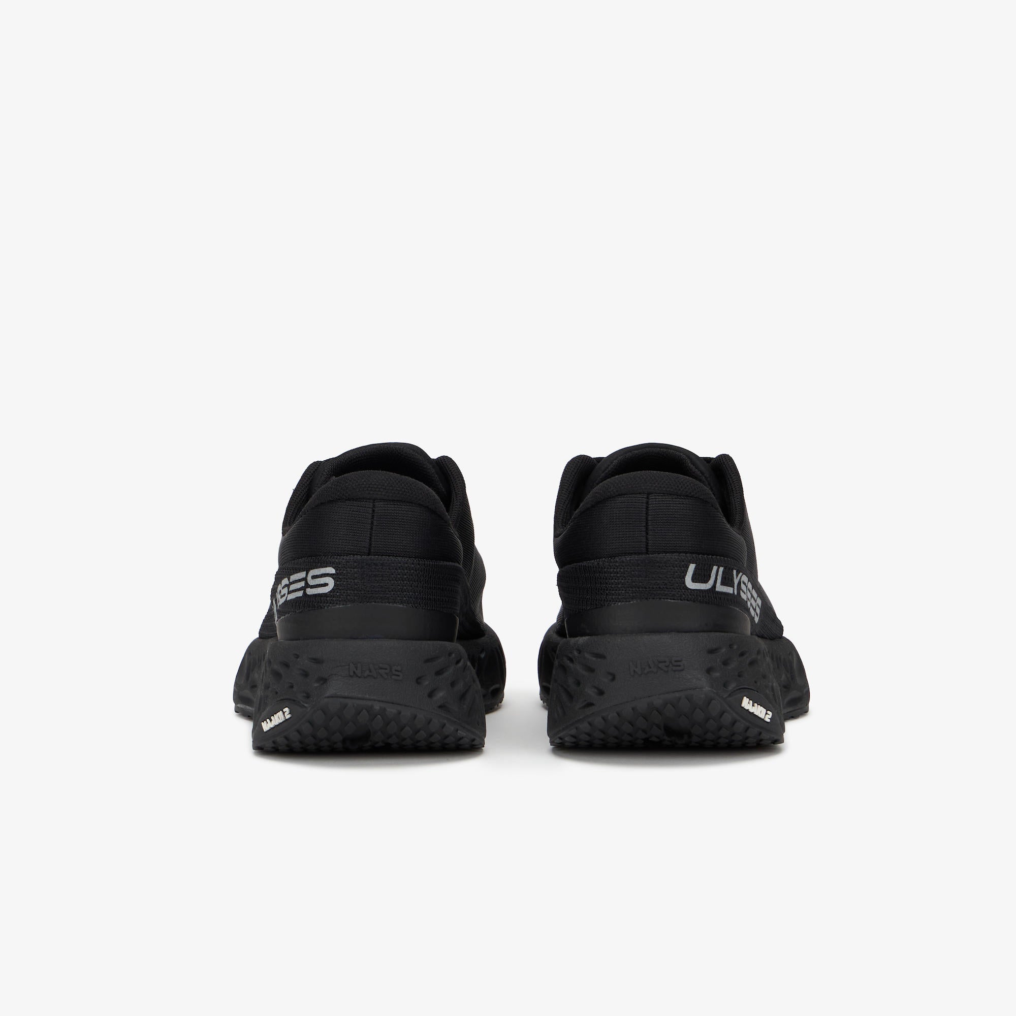 Black running shoes shown from the rear, featuring textured black soles 