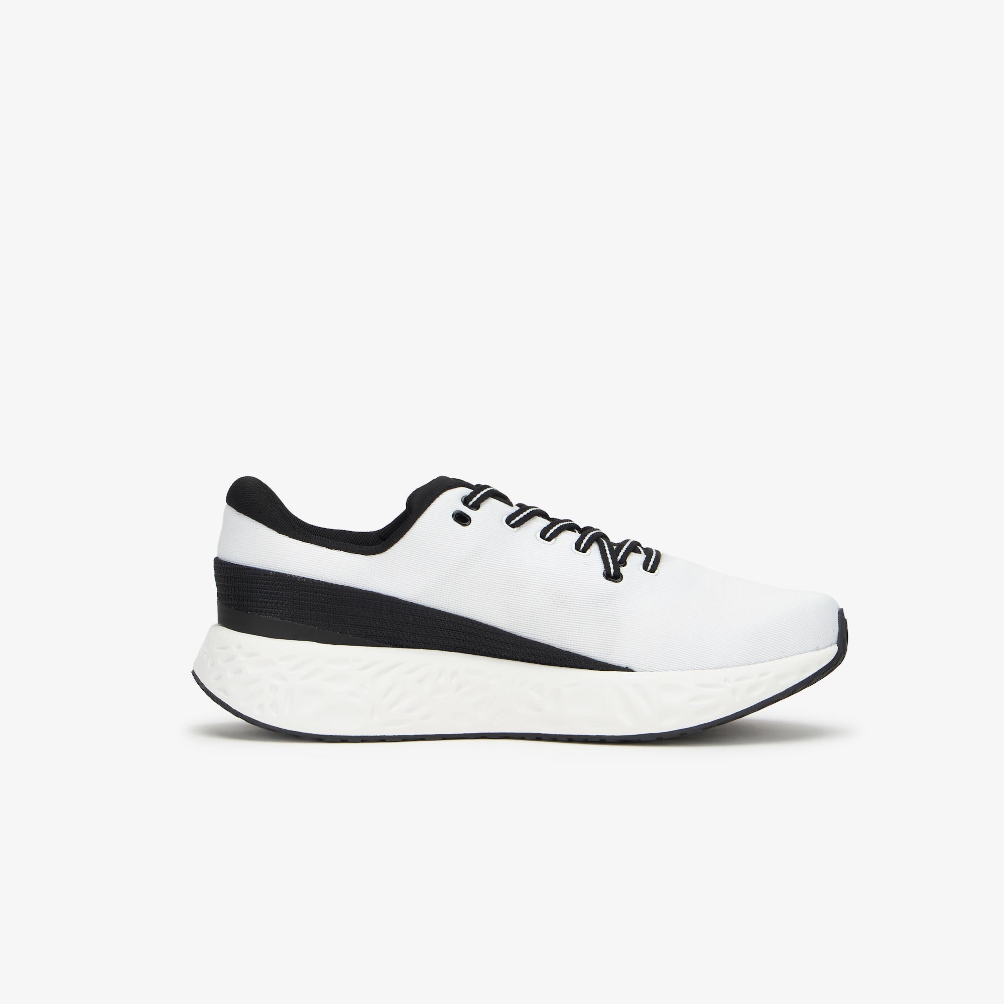 A white and black ULYSSES NAAKII  sneaker shown from the side profile against a clean, light gray background.