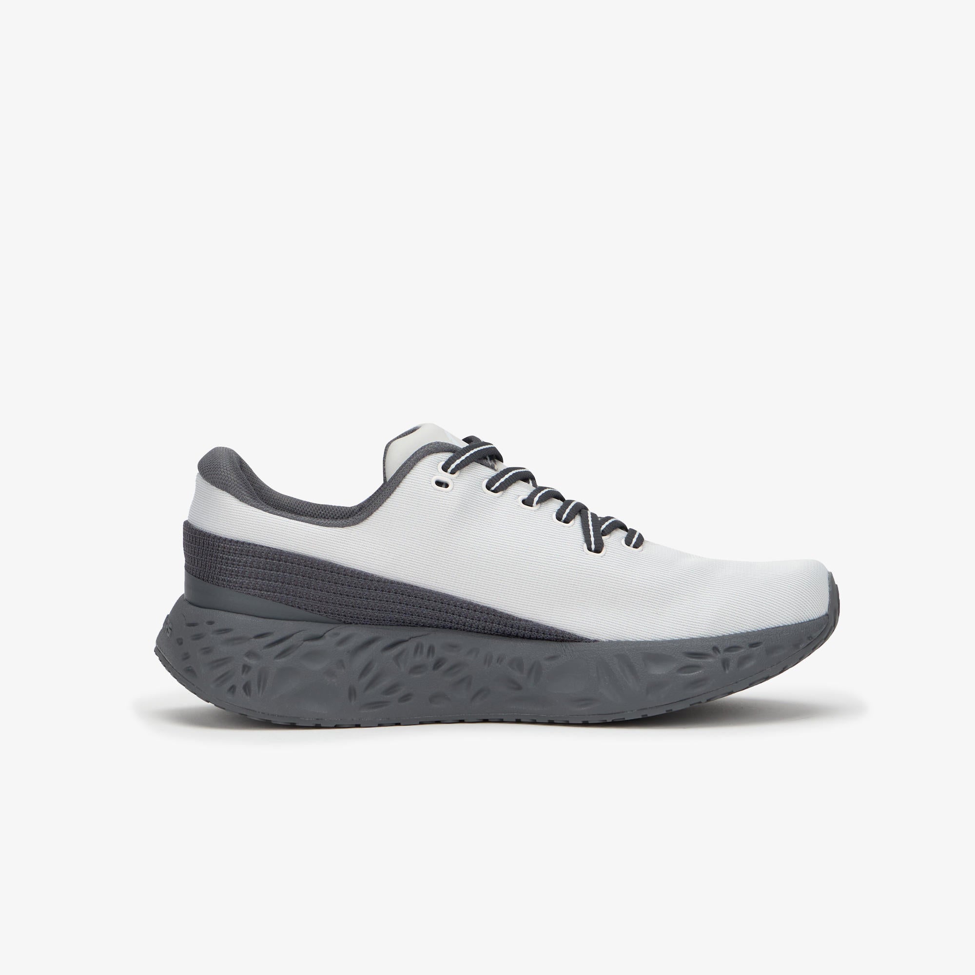A white and dark gray athletic sneaker shown from the side profile against a light gray background.