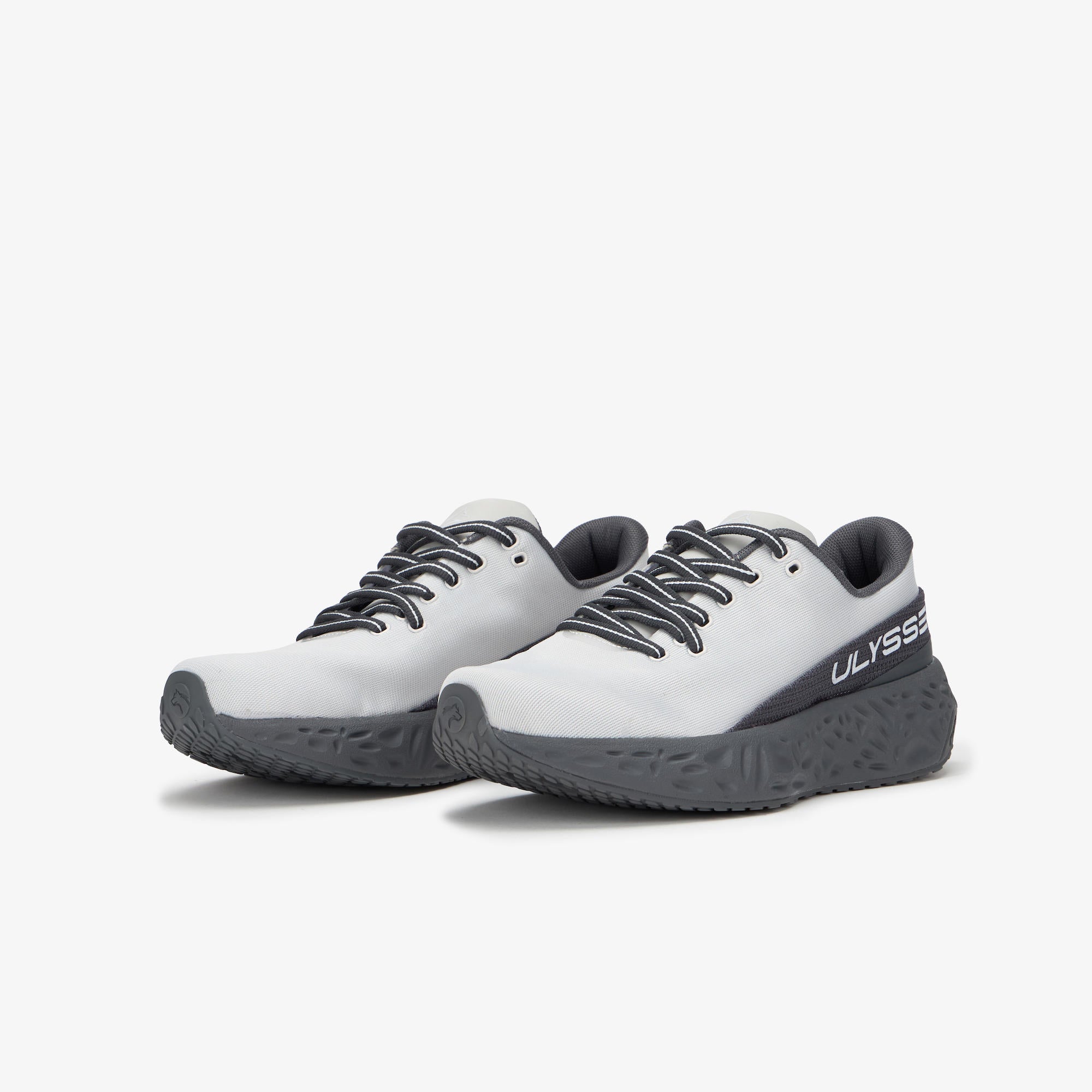 White sneaker with ULYSSES logo on a light gray background