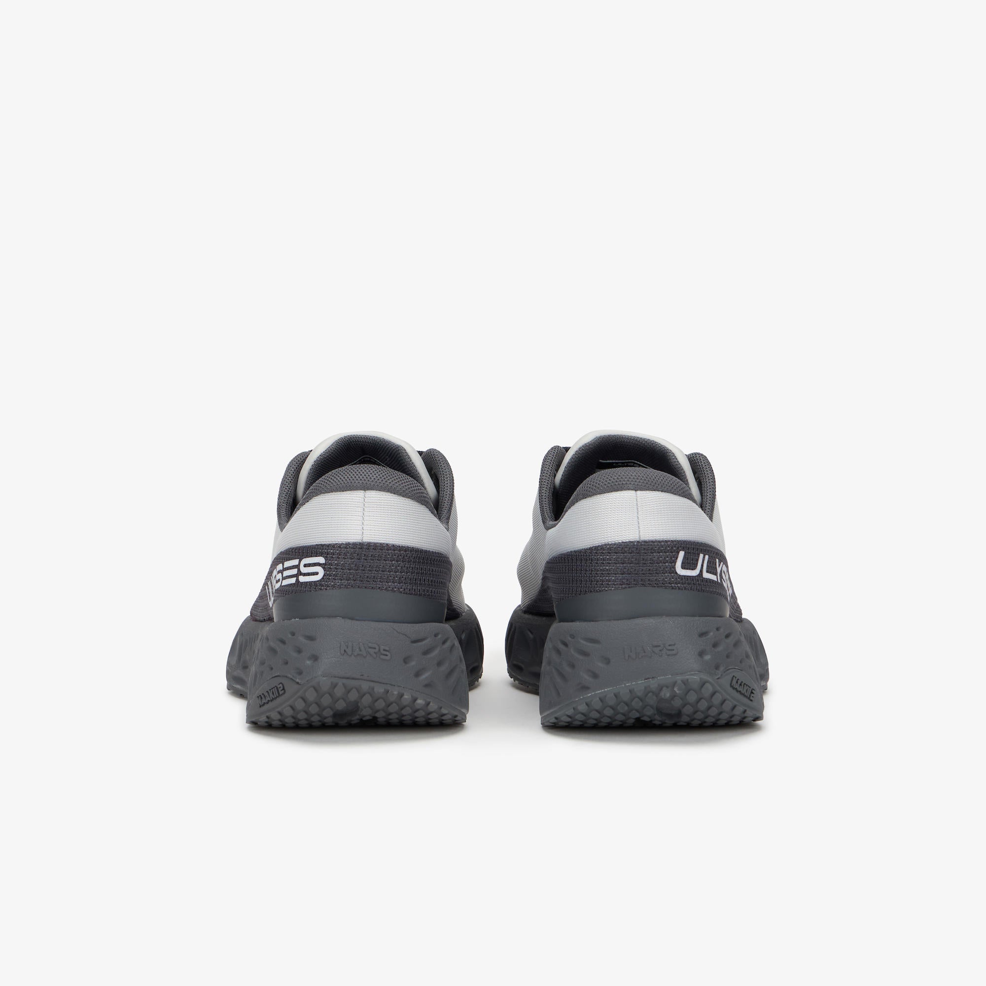 A pair of gray and black ULYSSES NAAKII  running shoes shown from the back,
