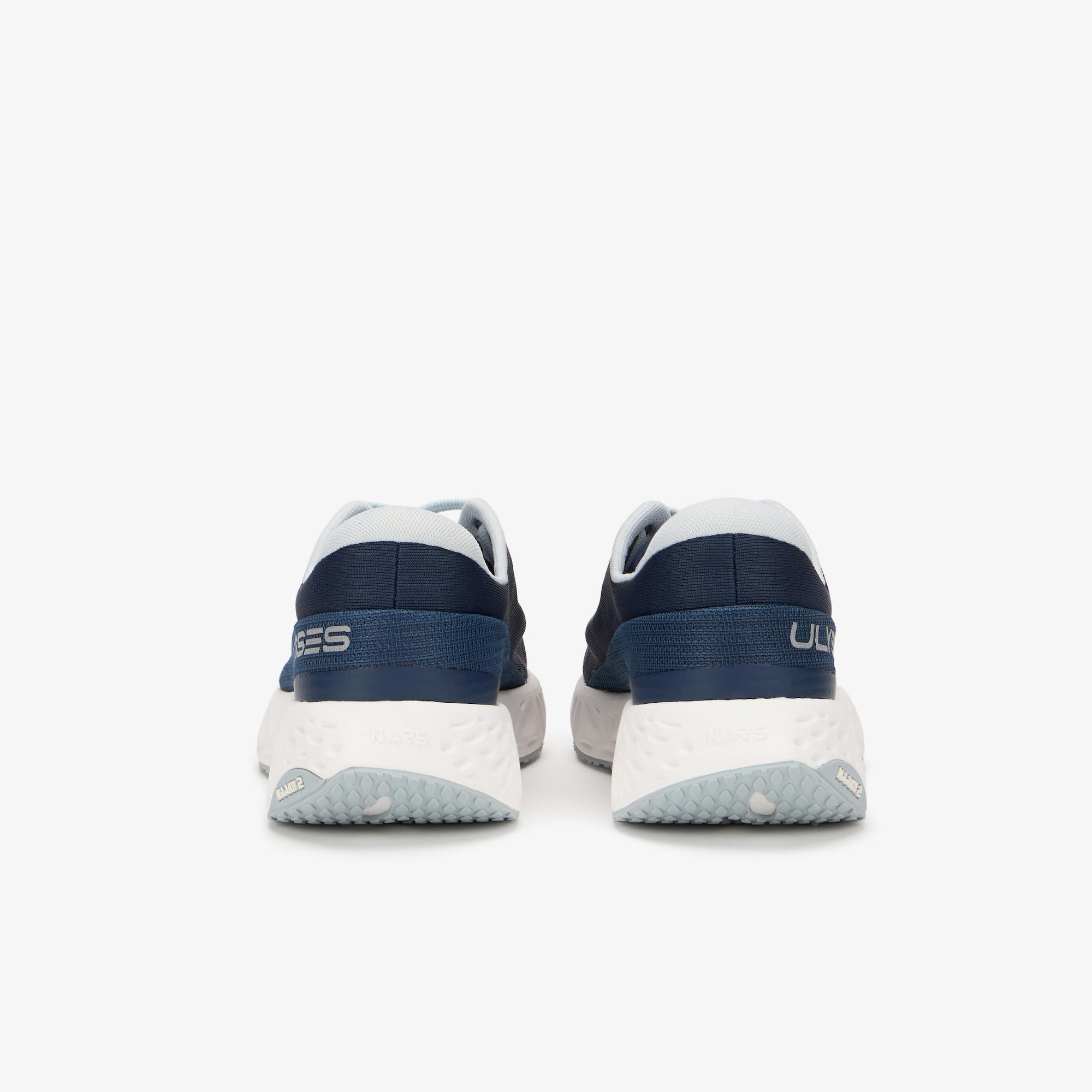 A pair of running shoes shown from the rear, featuring navy blue and white panels with a textured white midsole and light gray outsole, on a light gray background.