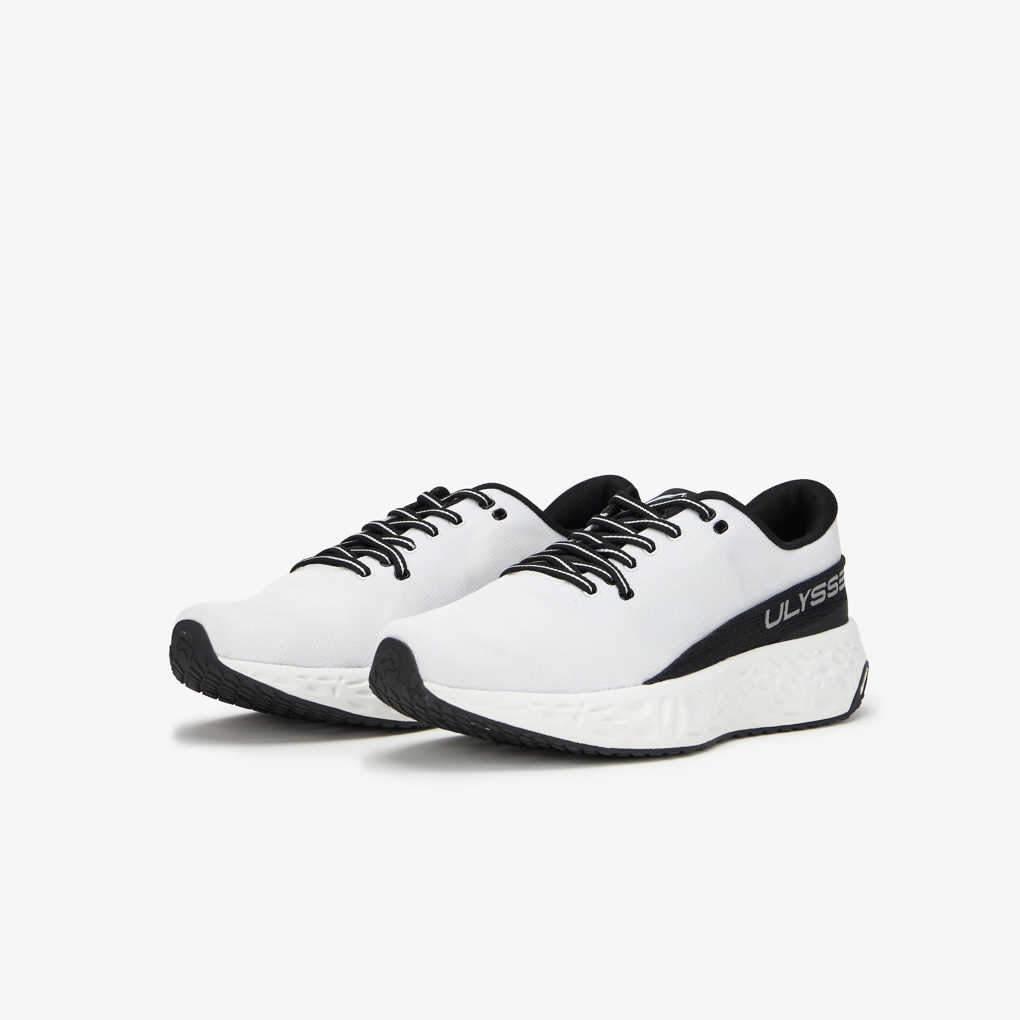 A pair of white running shoes with black accents, including the laces, outsole, heel counter, and a black side stripe featuring the 'ULYSSES' brand name, set against a plain light gray background.