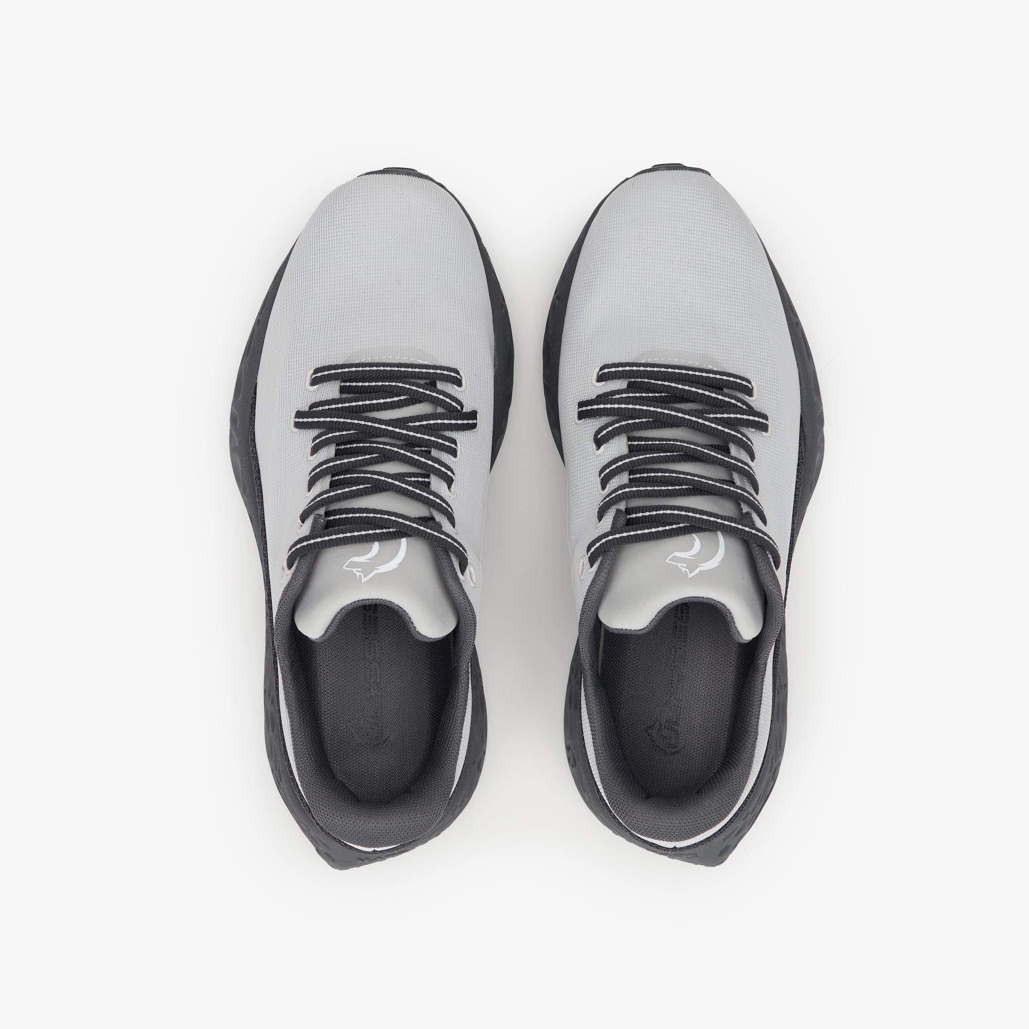 A pair of low-top athletic sneakers shown from a top-down view on a clean white background. The shoes feature a light gray upper, black laces, and a black sole.