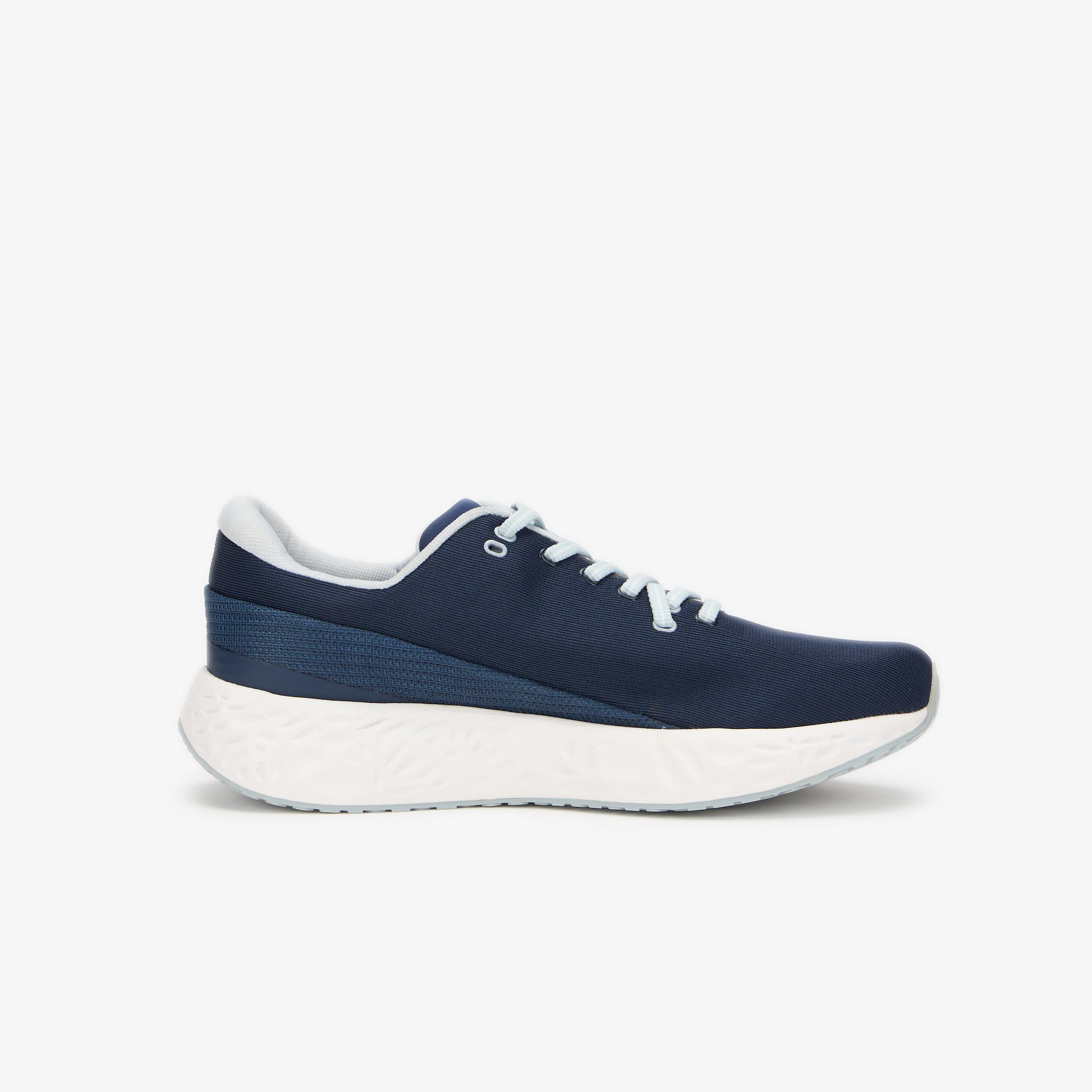 A navy blue ULYSSES NAAKII  sneaker with a thick white cushioned sole, white laces, and a white inner lining, shown from a side profile on a light gray background.