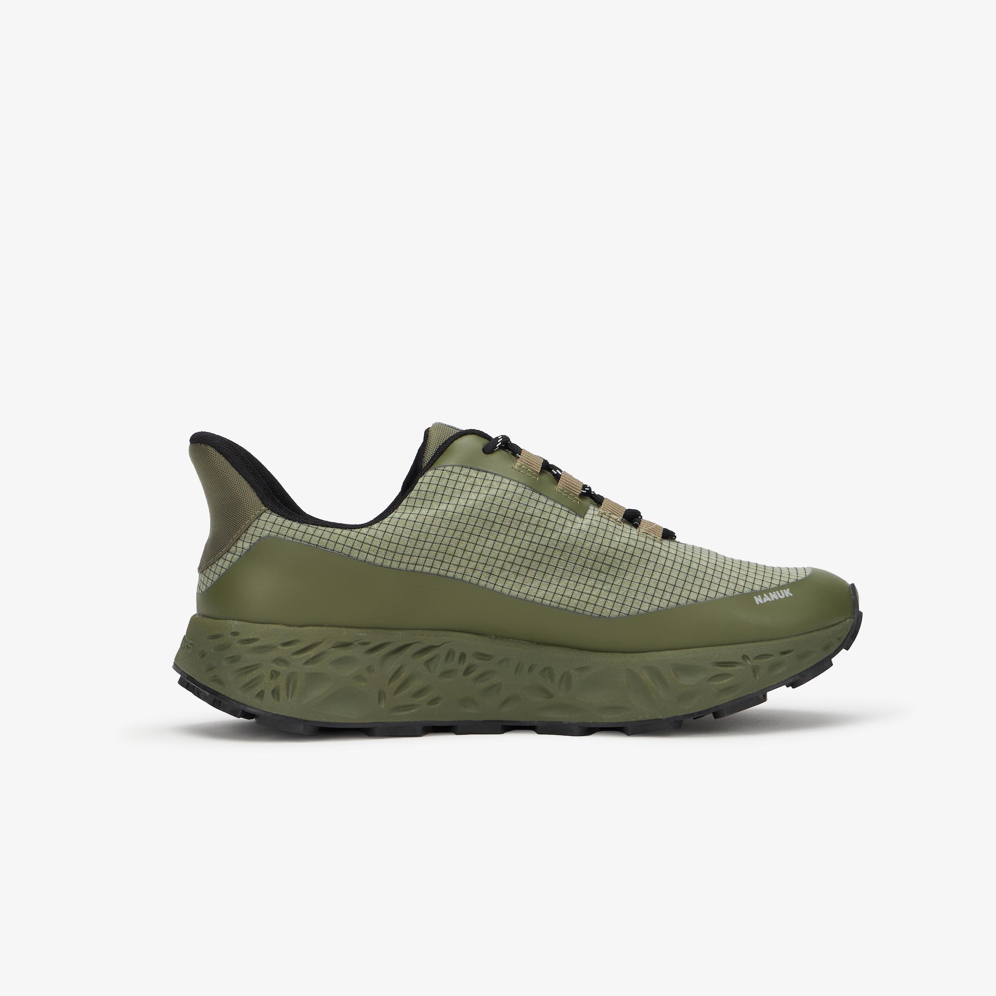 An olive green athletic shoe with a textured mesh upper, black laces, and a chunky sculpted sole, shown from a side profile on a light gray background.