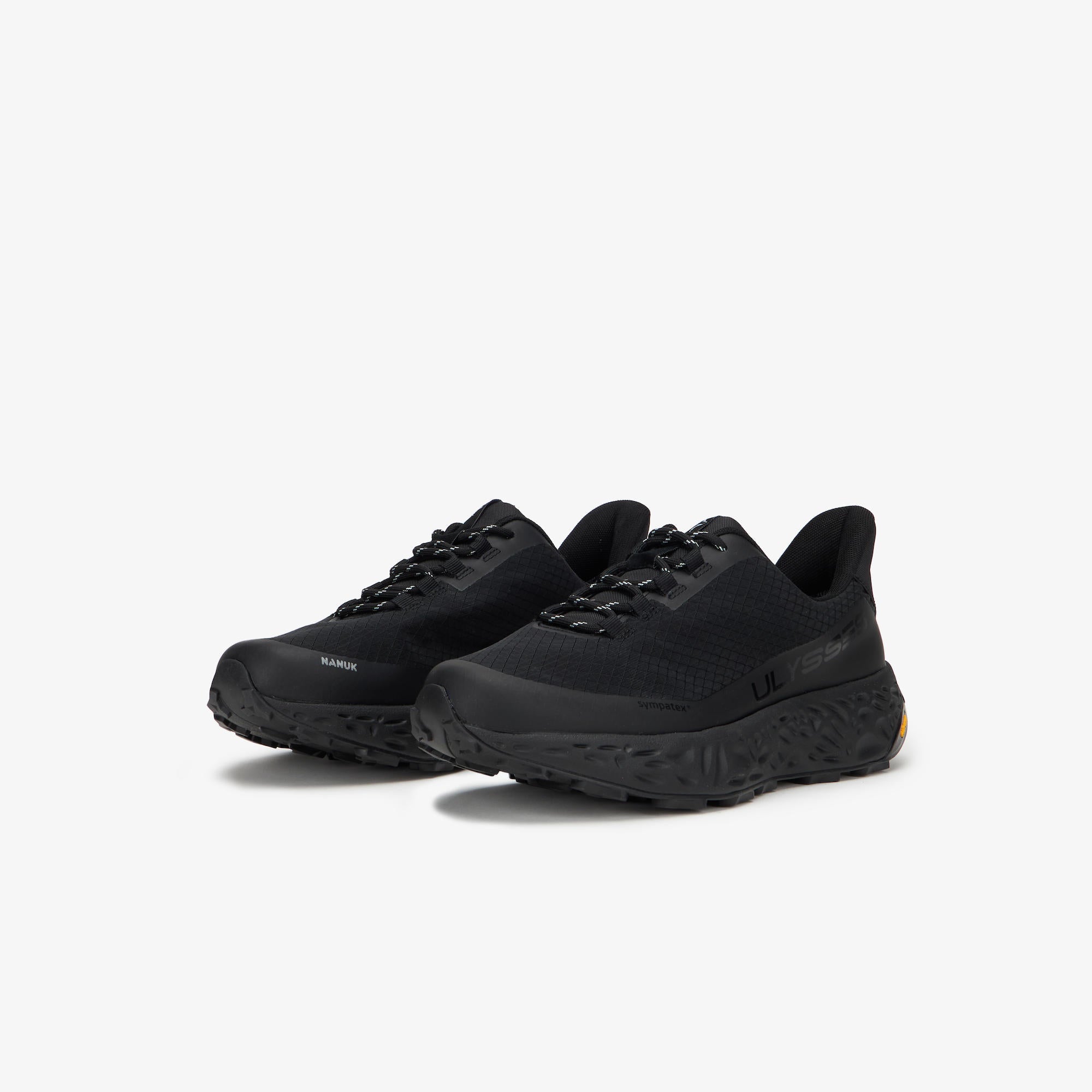 A pair of black trail running shoes with textured soles and black laces, displayed on a clean white background.