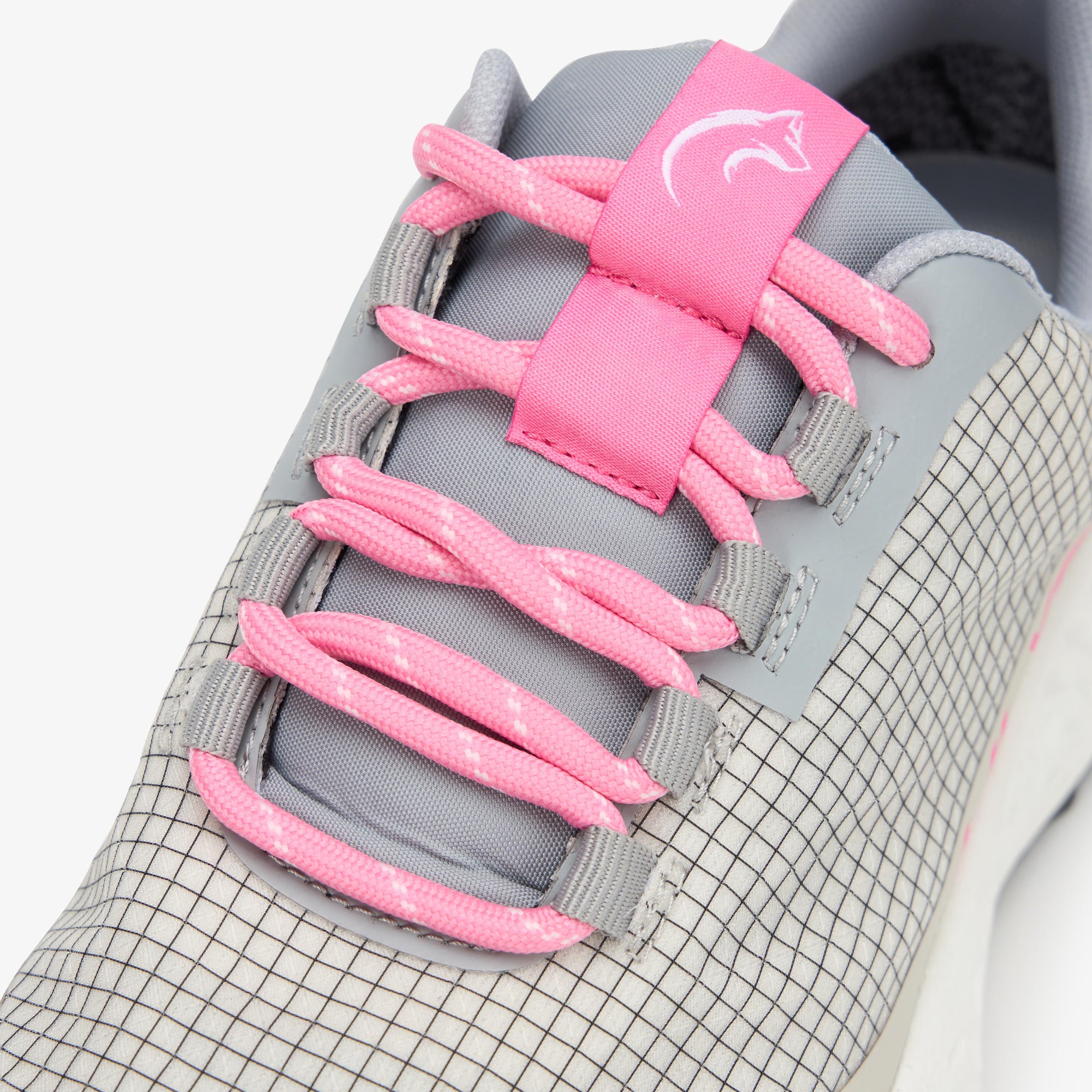 Close-up of a gray and white grid-patterned ULYSSES NANUK with bright pink laces and a pink tongue label featuring a white wolf logo.