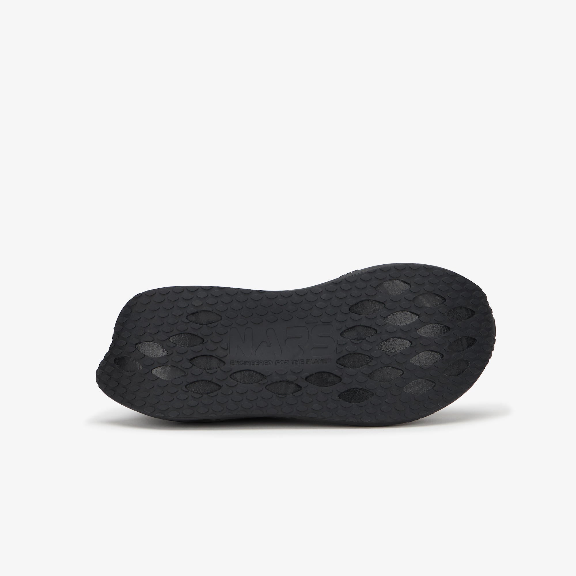 The black textured rubber outsole of a shoe, shown from a side profile view against a light gray background.
