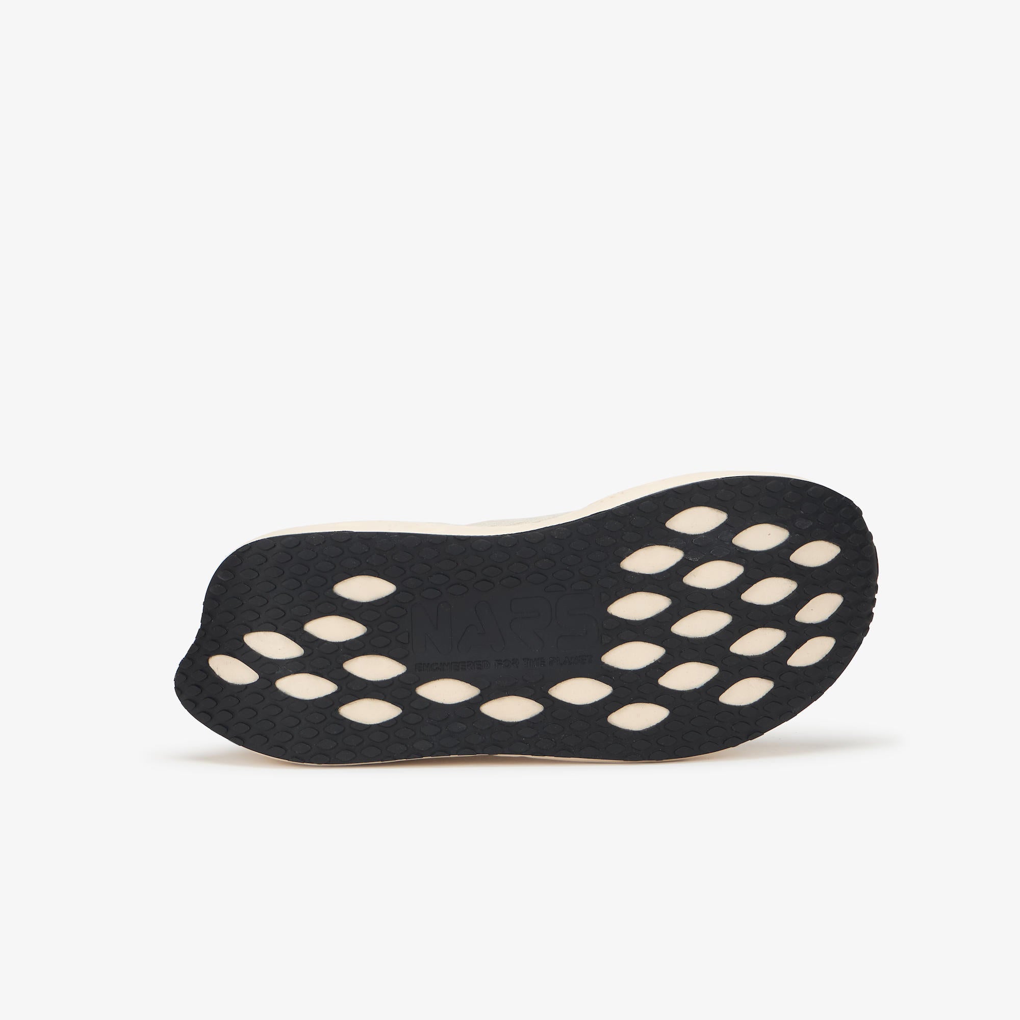 A black athletic shoe sole with circular cutouts, shown from the bottom against a light gray background.