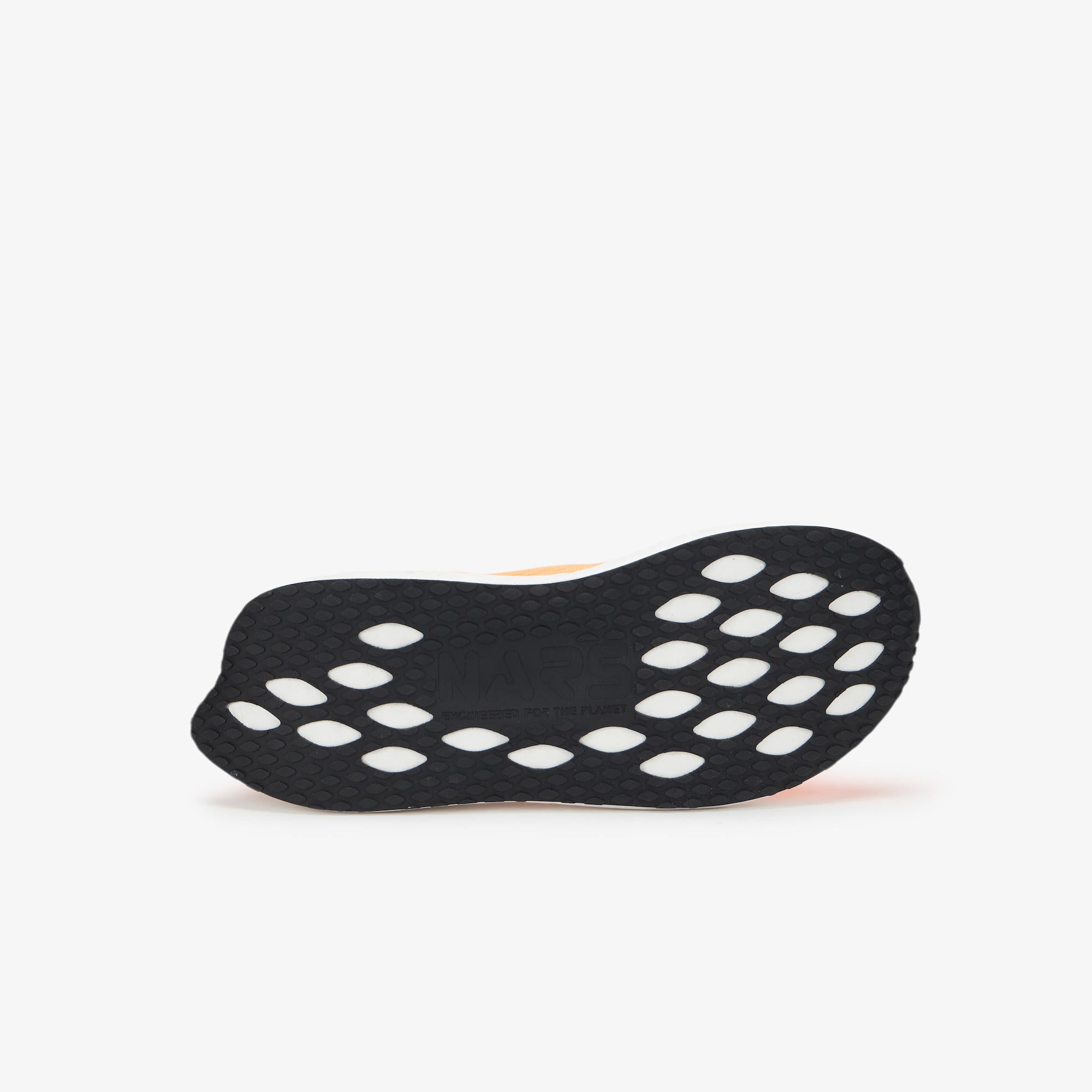 A black athletic shoe sole with a textured grip and circular cutouts, shown from a side profile view against a light gray background.