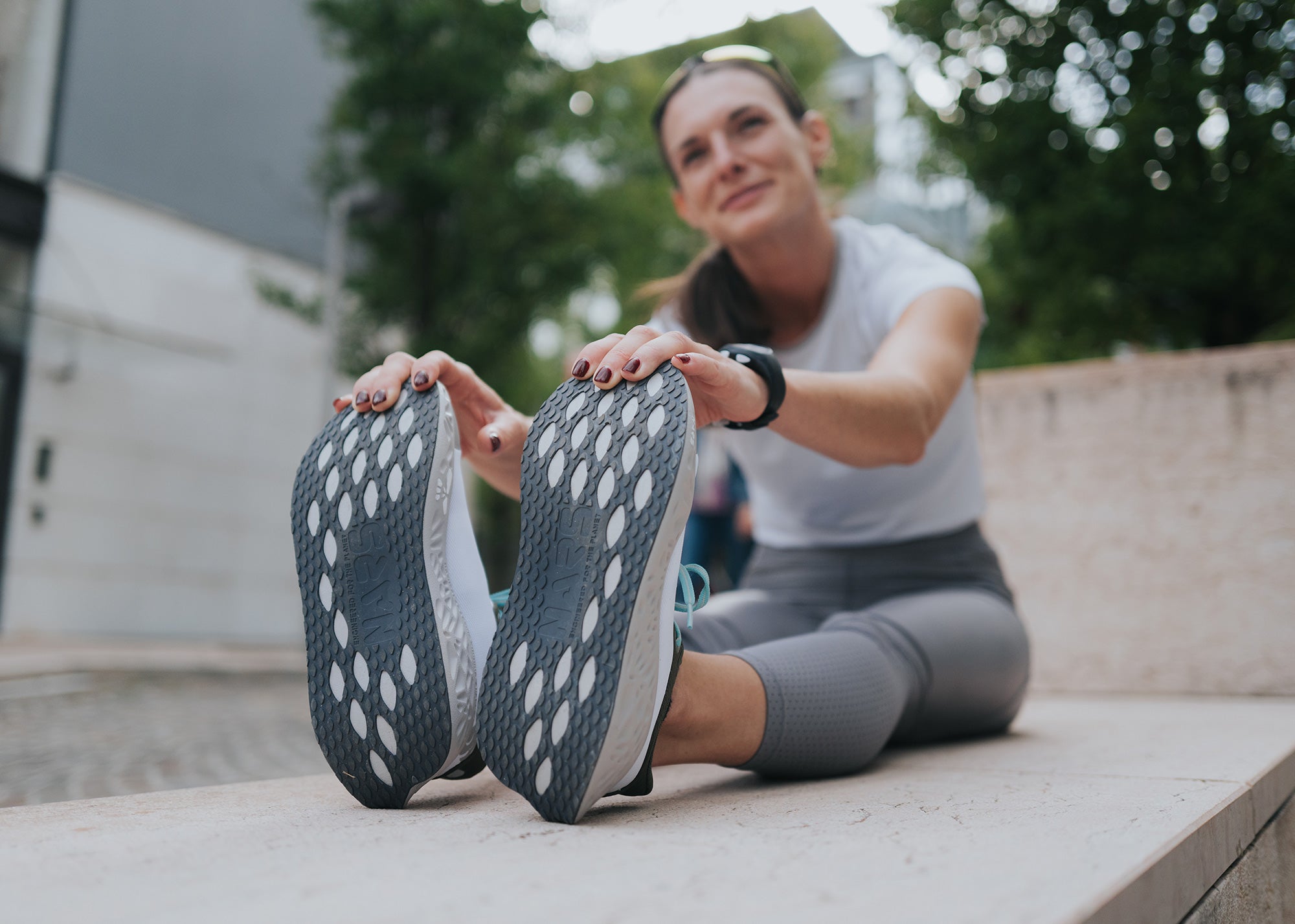 Close-up of road running shoes during seated stretch